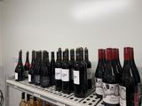 plusieurs bouteilles de vin posées sur une étagère dans une pièce