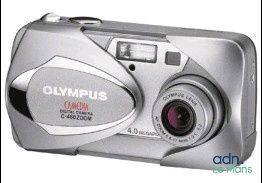 an image of a silver camera with a red lens on a white background