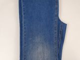 a pair of blue jeans on a hanger on a white background