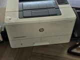 a printer that is sitting on a desk next to a phone