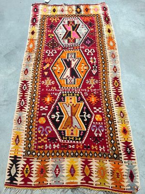 a red and yellow rug sitting on top of a blue floor