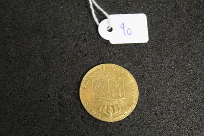 a close up of a gold coin with a price tag on it