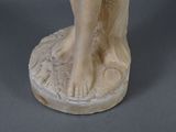 a statue of a woman standing on a pedestal