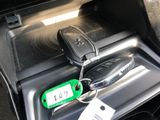 a car door handle with a key and a car keychain attached to it