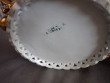 a white plate with a gold rim on a table