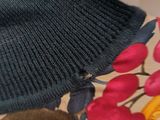 a black knitted hat sitting on top of a table