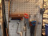 a picture of a work area with tools hanging on the wall