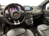 the interior of a small car with a steering wheel and dashboard