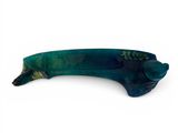 a blue and green fish shaped object on a white surface