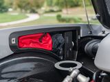 a close up of a car dashboard with a red bag in it