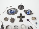 a lot of silver jewelry on a white surface