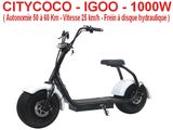 a white scooter sitting on top of a white floor next to a white wall