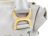 a close up of a purse with a gold buckle on it