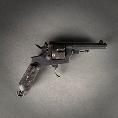 gun on a gray surface with a black background