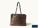 a chanel bag with a chain handle on a white background