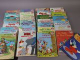 several children ' s books are lined up on a table