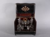 a small wooden box with wine glasses in it