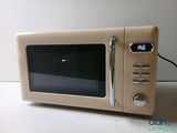 a small beige microwave with a digital clock on it