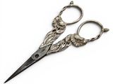 pair of antique scissors on a white surface with a white background
