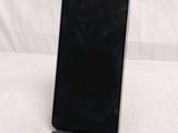 a close up of a cell phone on a stand on a white surface