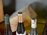 several bottles of wine are lined up on a table