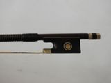a close up of a violin bow on a white surface