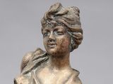 a statue of a woman with a bird on her shoulder