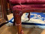 a red chair that is sitting on a blue rug