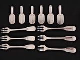 a lot of forks and spoons that are on a table
