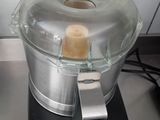 a small food processor on a counter with a lid