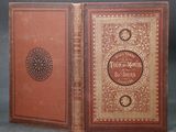 un vieux livre à la couverture rouge et à la bordure dorée