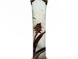 a vase that has a flower on it on a stand