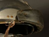 a close up of a helmet with a leather strap
