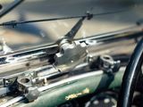 a close up of a green motorcycle with a steering wheel
