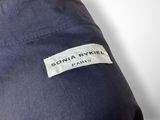a close up of a blue jacket with a label on it