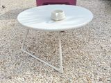 a white table with a cup on top of it