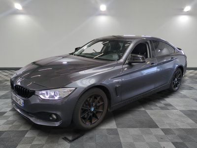 a picture of a grey bmw car parked in a showroom
