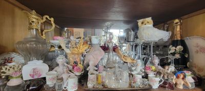 a lot of glass items on a shelf in a room