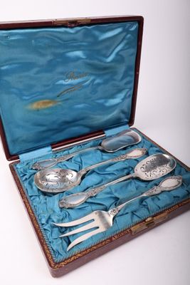 a case with silverware in it on a blue cloth