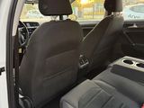 the back seat of a white car with a black seat belt