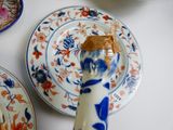 a blue and white vase with a piece of peanut butter on it