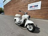 a white motorcycle parked in front of a building