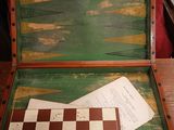 a wooden box with a chess board inside of it on a table