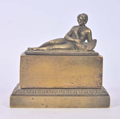 bronze statue of a woman reclining on a box on a white background