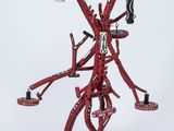sculpture of a red and black sculpture of a man with arms and legs