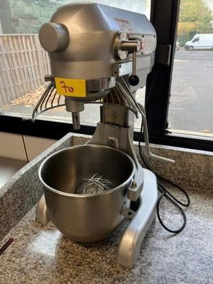 a mixer sitting on a counter in front of a window