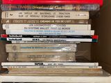books in a cardboard box are stacked on top of each other