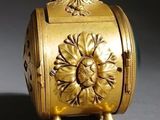 a gold box with a bird on top of it