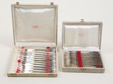 silverware in a silver case with red handles and a red handle