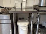 a kitchen with a sink, stove, and pots and pans